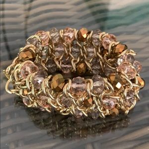 Gold bracelet with pink and purple crystals